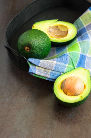 avocado on a dark wood background. tinting. selective focus
