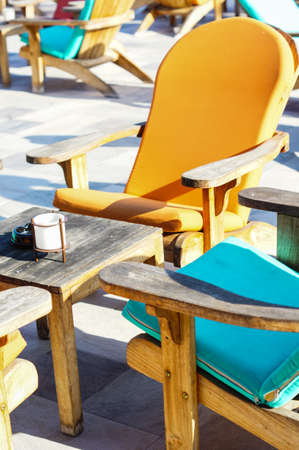 Wooden sun chair on outdoor deck cafe overlooking the Mediterranean Seaの写真素材