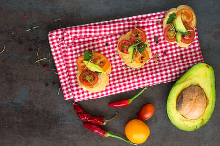Bruschetta with tomato, avocado, chilli peper and herbsの写真素材