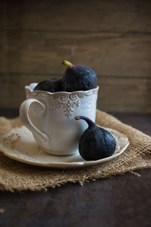 Ripe fig fruits on the dark vintage background. Selective focus
