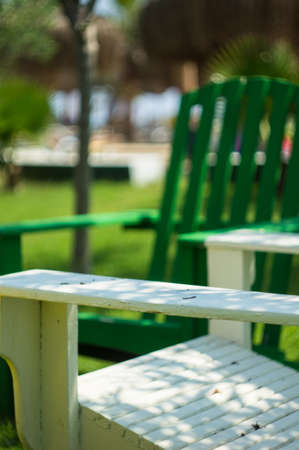 Bright color wooden sun chairs in the beach gardenの写真素材