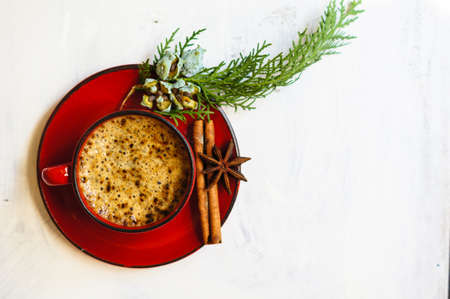 Red cup of black coffee with Good morning note and christmas time spices, sticks of cinnamon and anise starの写真素材