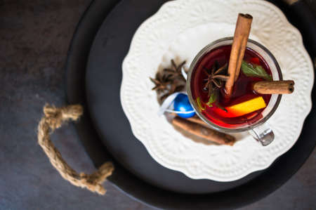 Mulled wine with spices on wooden backgroundの写真素材