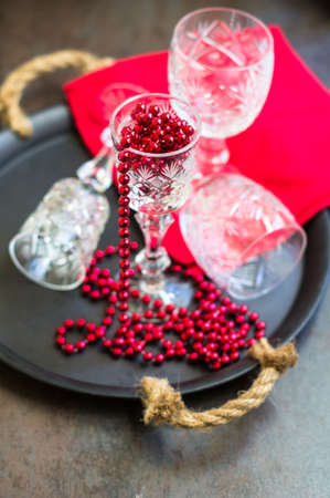 Vintage crystal glasses on the black tray with christmas decorations. Selective focusの写真素材