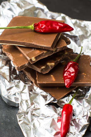Spice red chilli peppers and chocolate, selective focus