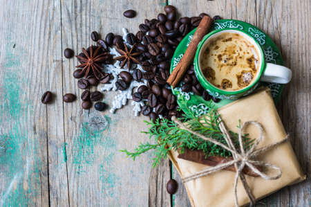 Cup of coffee and coffee beans with christmas presents and decorationsの写真素材
