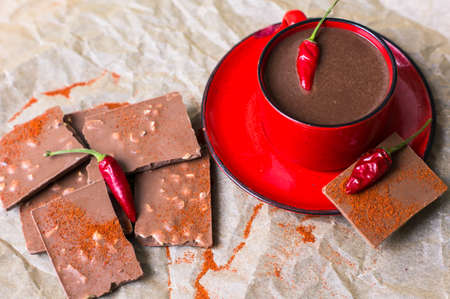 Red cup of hot chocolate with red pepper, selective focusの写真素材