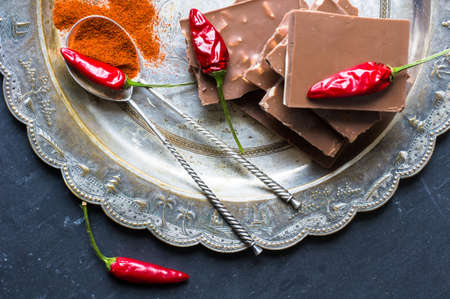 Spice red chilli peppers and chocolate, selective focus