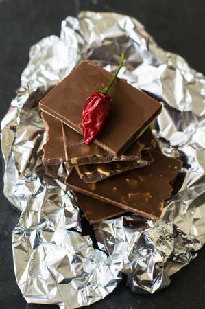 Spice red chilli peppers and chocolate, selective focus