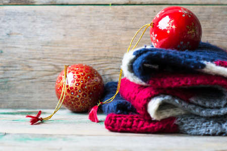 Christmas Balls on Knitted Gifts on wooden backgroundの写真素材