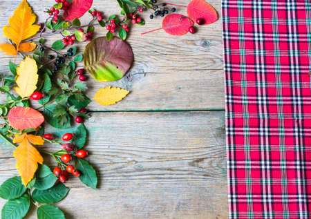 presents with autumn leaves decoration on rustic wooden background in Autumn holidaysの写真素材