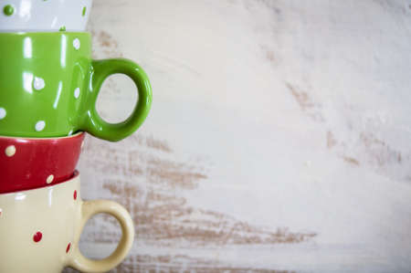 Multi colored empty big polka dot bowls on the wooden table in rustic styleの写真素材