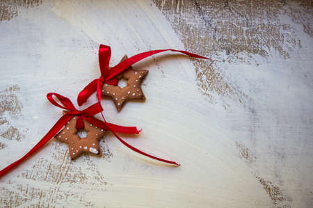 Gingerbread cookies star and heart  shaped  over wooden backgroundの写真素材