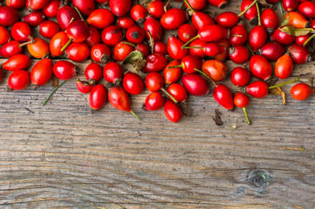 Ripe rose hip on the old wooden backgroundの写真素材