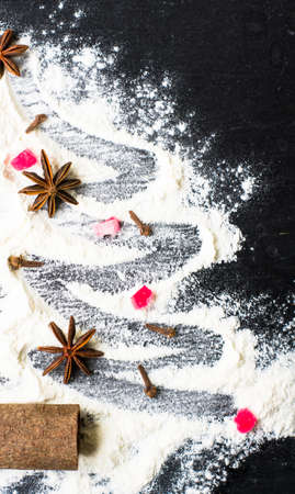 Christmas tree with the flour, cinnamon and anise star spices as a decoration (homemade baking)の写真素材