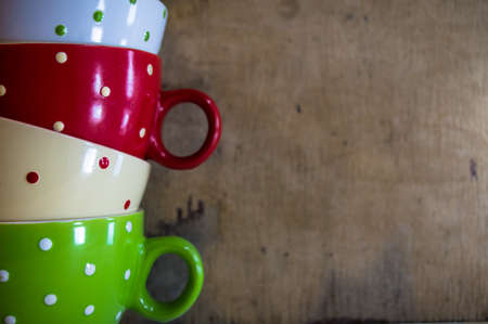 Multi colored empty big polka dot bowls on the wooden table in rustic styleの写真素材