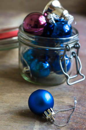 Christmas time decorations with balls and christmas candy on old wooden backgroundの写真素材