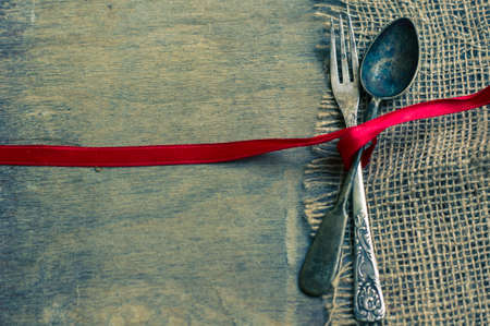 Vintage silverware with christmas decorations on rustic background. toned imageの写真素材