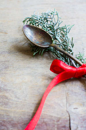 Vintage spoon with red ribbon on old white wooden tableの写真素材