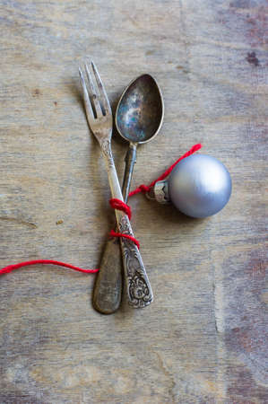 Vintage silverware with christmas decorations on rustic backgroundの写真素材