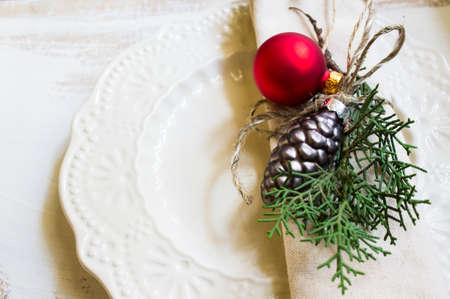 Christmas table setting with vintage silverware and napkin with christmas balls decorationsの写真素材