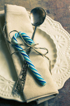 Christmas table setting with napkin and Christmas decorations. Toned imageの写真素材