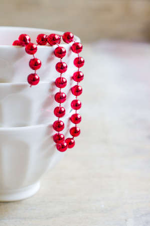 White vintage style bowls with christmas decorations on old wooden backgroundの写真素材