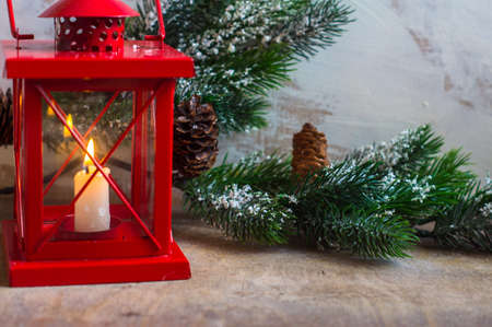 Christmas time interior decorations on the rustic background with candle lamp and fir treeの写真素材