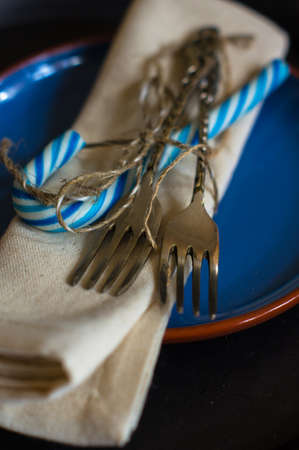 Christmas time table setting with vintage silverware on plate and napkin.の写真素材