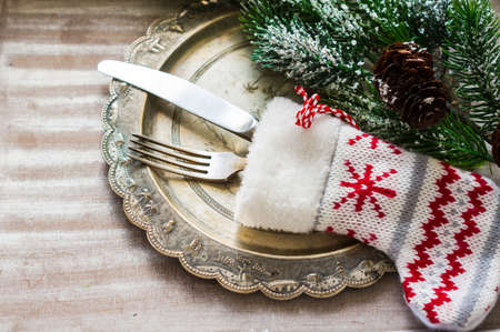 Christmas time table setting with vintage silverware on plate and napkin.の写真素材