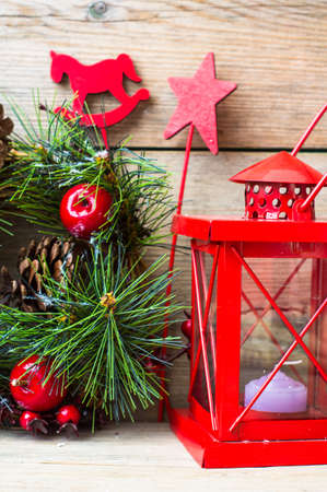 Christmas time interior decorations on the rustic background with candle lamp and fir tree