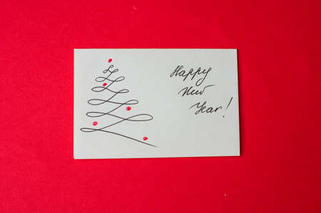 Holiday card with christmas time decorations on red backgroundの写真素材
