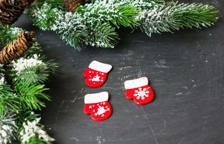 Christmas time interior decorations on the black background with fir tree, pine cones, angels and...