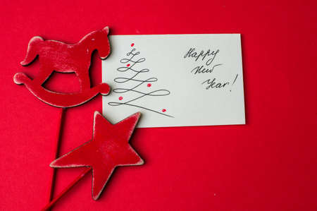 Holiday card with christmas time decorations on red backgroundの写真素材