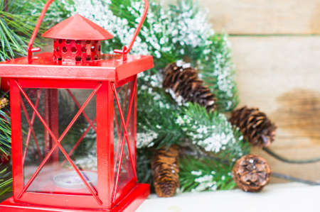 Christmas time interior decorations on the rustic background with candle lamp and fir treeの写真素材