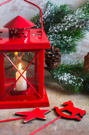 Christmas time interior decorations on the rustic background with candle lamp and fir treeの写真素材