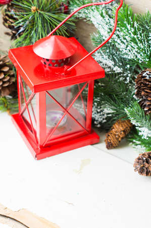 Christmas time interior decorations on the rustic background with candle lamp and fir treeの写真素材