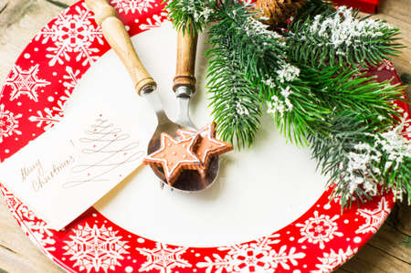 Christmas time table setting with vintage silverware on plate and napkin.の写真素材