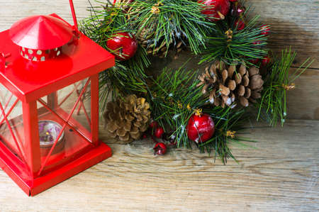 Christmas time interior decorations on the rustic background with candle lamp and fir treeの写真素材