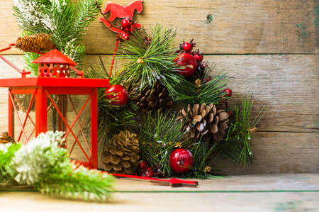 Christmas time interior decorations on the rustic background with candle lamp and fir treeの写真素材