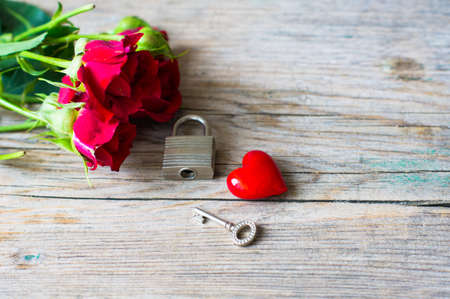 red roses and heart present on rustic background. Selective focusの写真素材