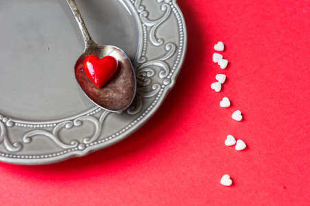 Valentines table setting with vintage silverware and red heart as a decorationの写真素材