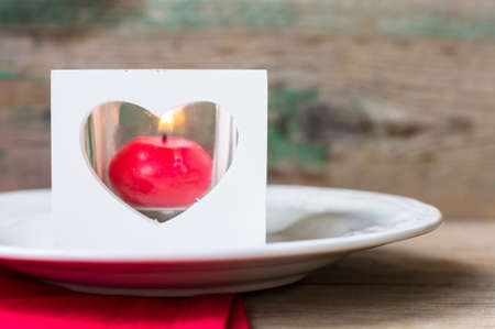 Valentines table setting with vintage silverware and red heart as a decorationの写真素材