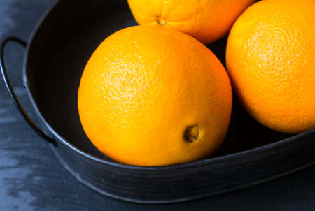 Ripe orange fruits on the vintage trayの写真素材