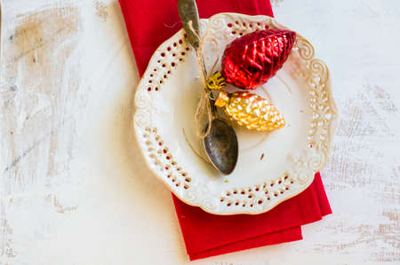 Christmas table setting with vintage silverware and christmas decoration on rustic wooden table