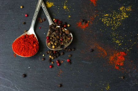 Paprika pepper spices and vintage silverware on rustic backgroundの写真素材