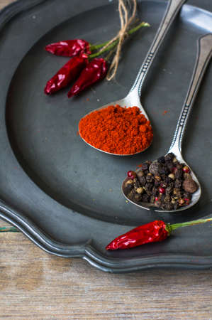 Paprika pepper spices and vintage silverware on rustic backgroundの写真素材