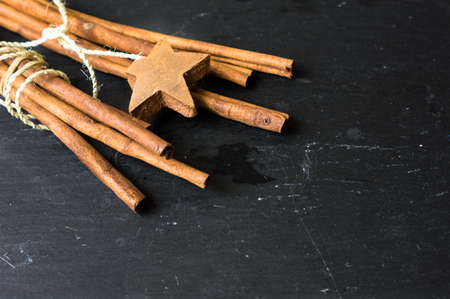 Sticks of cinnamon spice on black stone backgroundの写真素材