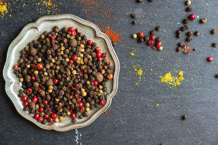 Paprika pepper spices and wintage silverware on rustic background