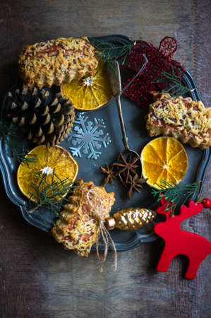 Christmas sweets and spices on vintage plate on wooden rustic backgroundの写真素材